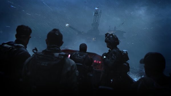 Game screenshot from Call of Duty®: Modern Warfare® II showing soldiers approaching an oil rig at night in stormy weather.