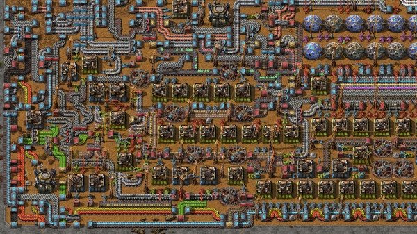A Factorio screenshot showing a complex factory setup with conveyor belts, furnaces, and assembly machines in a detailed layout.