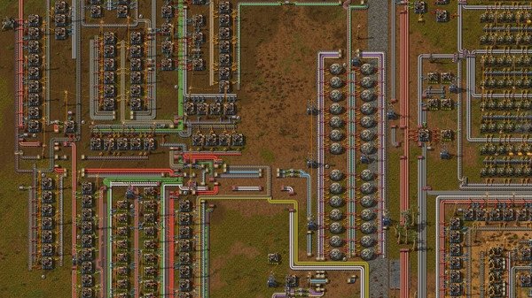 Factorio screenshot showing a sprawling factory setup with conveyor belts, machines, pipes, and storage tanks in a grassy area.