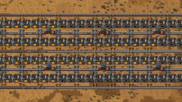Factorio screenshot showing a large assembly line with conveyor belts, machines, and robotic arms on a desert-themed terrain.
