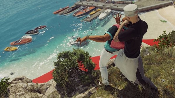 Screenshot from HITMAN World of Assassination showing Agent 47 in a sailor outfit pushing a man off a cliff into the ocean.