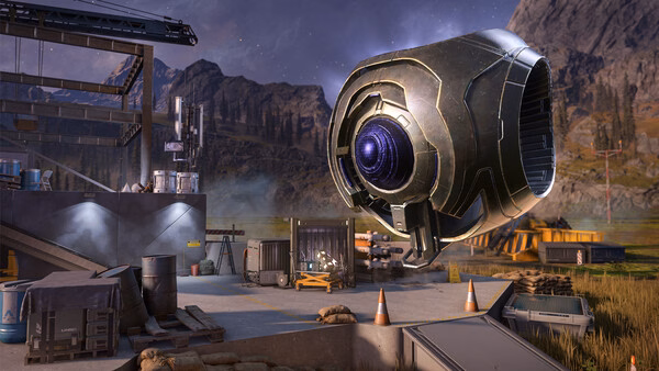Halo Infinite screenshot showing a large floating robot in a futuristic outdoor base surrounded by mountains and construction materials.