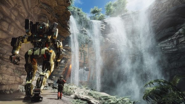 Titanfall® 2 screenshot featuring a towering mech and its pilot exploring a lush canyon with cascading waterfalls.