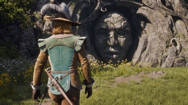 A screenshot from Fable showing a character in a green outfit and hat, standing near a stone structure surrounded by grass and flowers.