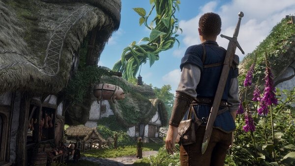 Fable screenshot: A character with a sword gazes at a giant beanstalk near quaint cottages under a blue sky.
