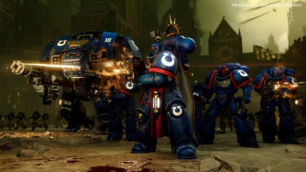Total War: WARHAMMER 40,000 screenshot: Space Marines in blue armor firing guns amidst a battle in a gothic cityscape.