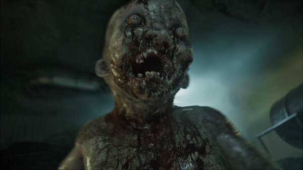 Screenshot from the horror game ILL, showing a grotesque, blood-covered creature with sharp teeth in a dimly lit environment.