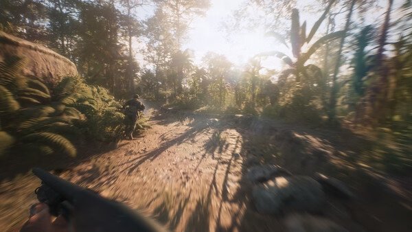 A Hell Let Loose: Vietnam screenshot showing a soldier running through a dense jungle with sunlight filtering through trees.