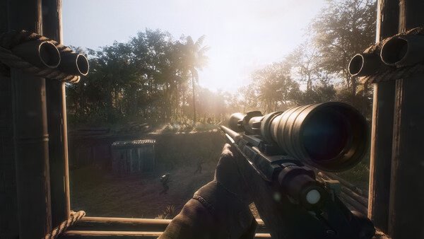 Screenshot from Hell Let Loose: Vietnam showing a sniper aiming through a scope at soldiers in a sunlit jungle setting.