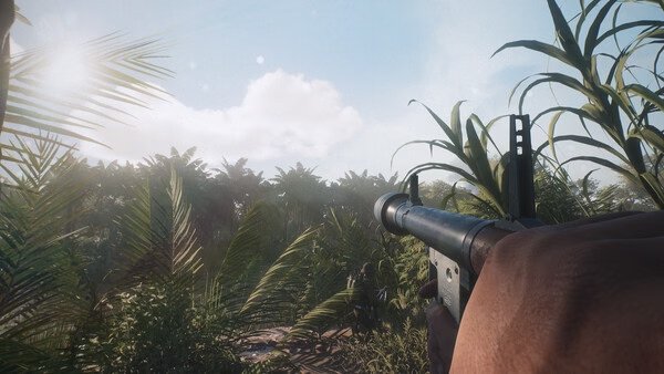 Screenshot from Hell Let Loose: Vietnam showing a player's perspective holding a gun in a dense jungle environment.