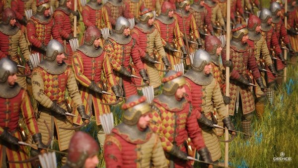 Screenshot from Chronicles: Medieval showing a group of armored archers standing in formation on a grassy field.