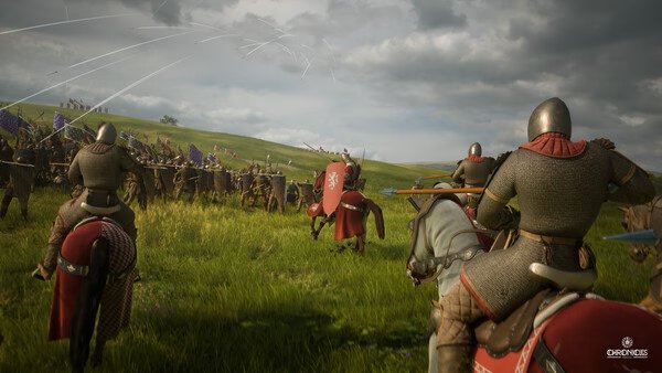 Knights on horseback charge into a battle against soldiers in a grassy field in this Chronicles: Medieval screenshot.
