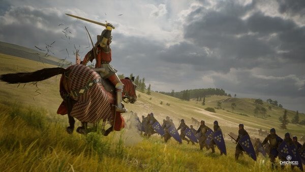 A screenshot from Chronicles: Medieval showing a knight on horseback charging at a line of shielded soldiers in a grassy battlefield.