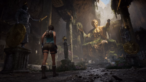 Screenshot from Tomb Raider: Legacy of Atlantis showing Lara Croft facing a large, ancient statue in a cavern.