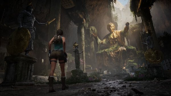 Screenshot from Tomb Raider: Legacy of Atlantis showing Lara Croft facing a large, ancient statue in a cavern.