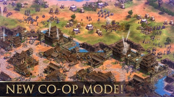 Screenshot of Age of Empires II showing a detailed battle scene with armies, buildings, and terrain in a new co-op mode.