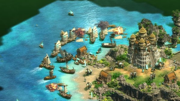 Age of Empires II screenshot showing a coastal battle with ships, fire, and a fortified structure near a shoreline.