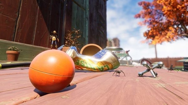 Grounded screenshot: A tiny character stands on a wooden surface, surrounded by ants, a toy ball, and a soda can.