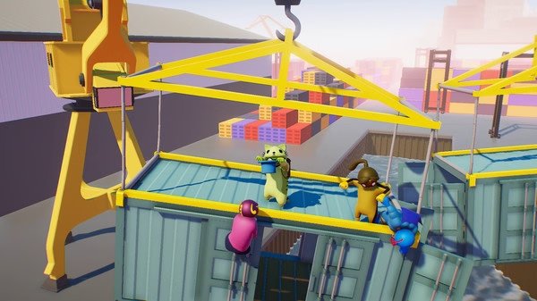 Gang Beasts screenshot: Colorful characters grapple on shipping containers near a crane in a dockyard setting.
