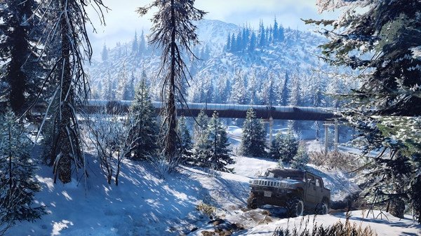 SnowRunner screenshot: A rugged vehicle navigates a snowy, forested landscape with a pipeline and mountains in the background.