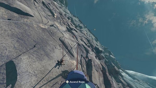 Screenshot from the game Cairn showing a climber ascending a steep rocky mountain face under a clear blue sky.