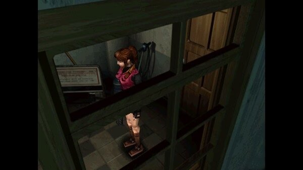 Screenshot from Resident Evil 2 (1998) showing a character in a small room with a stretcher and wooden door visible.