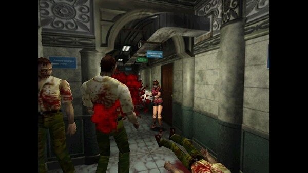 Resident Evil 2 (1998) screenshot: A character in red aims a gun at zombies in a detailed corridor environment.