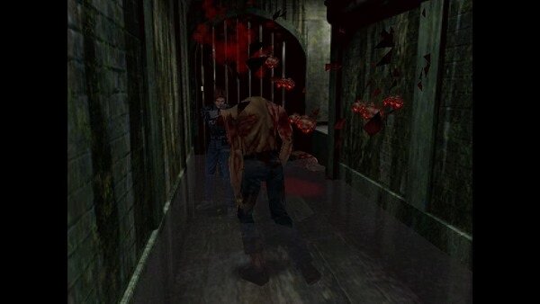 Resident Evil 2 (1998) screenshot: A player character faces a zombie in a dim, narrow hallway, with shattered debris suspended in midair.