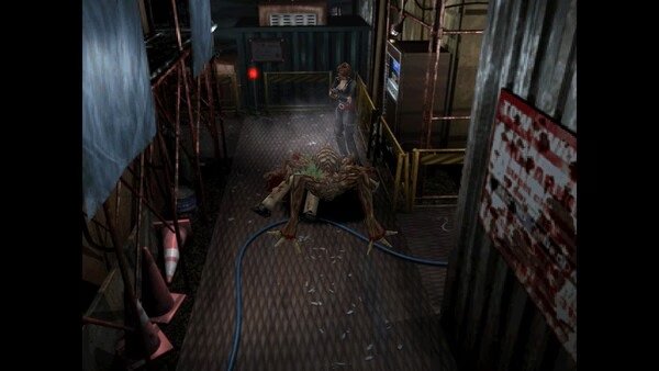 Resident Evil 3 Nemesis (1999) screenshot: A character stands over a defeated monster in a dimly lit industrial area with metal flooring.