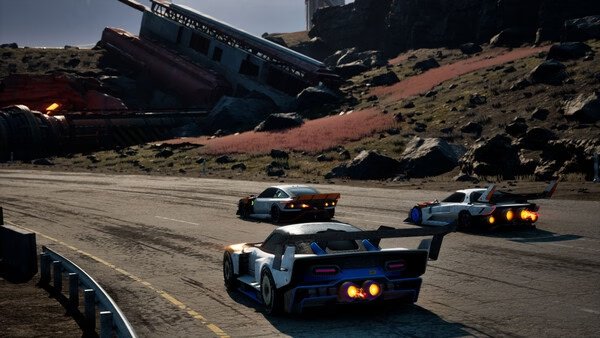 Screamer screenshot: Three racing cars speed down a rugged track with rocky terrain and old structures in the background.
