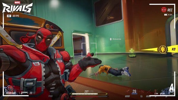 Marvel Rivals screenshot: A character in a red suit gestures towards a defeated opponent on the futuristic game map.