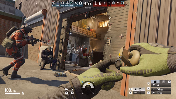 Screenshot from Tom Clancy's Rainbow Six Siege. Players prepare to breach a wooden structure with weapons and a grenade in hand.