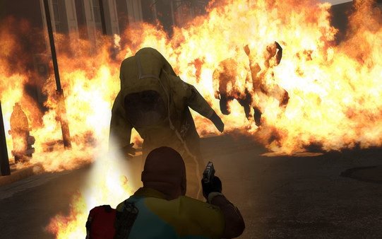 Screenshot from Left 4 Dead 2 showing a player character aiming at a zombie in a hazmat suit amidst a fiery background.