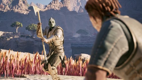 Avowed screenshot: A warrior with an axe confronts another character in a desert landscape with rocky cliffs and sparse trees.