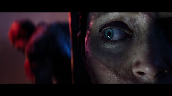 Hellblade II: Senua’s Saga screenshot: A blurred figure in motion against a dark, atmospheric background.