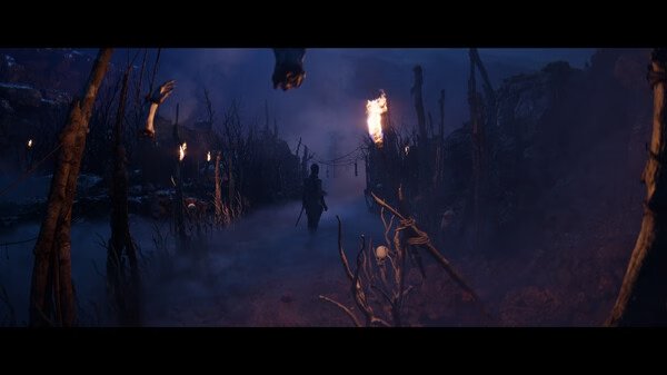 Screenshot from Hellblade II: Senua’s Saga showing a figure walking on a foggy path with torches lighting the way.
