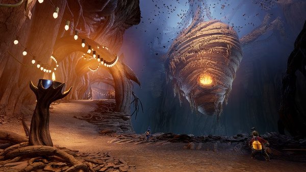 Screenshot from 'It Takes Two' shows a fantastical cave with swirling lights and a glowing, beehive-like structure in the background.