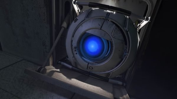 Portal 2 screenshot showing Wheatley, a white spherical robot with a glowing blue eye, positioned in a dimly lit industrial area.