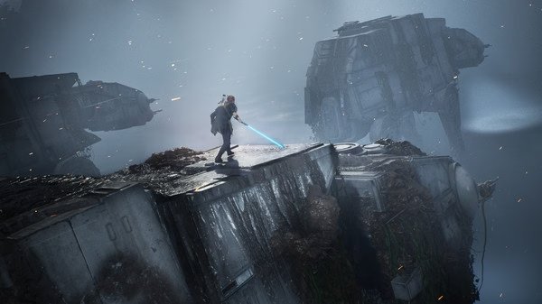 A screenshot from STAR WARS Jedi: Fallen Order showing the protagonist wielding a blue lightsaber on a fallen AT-AT in a misty landscape.