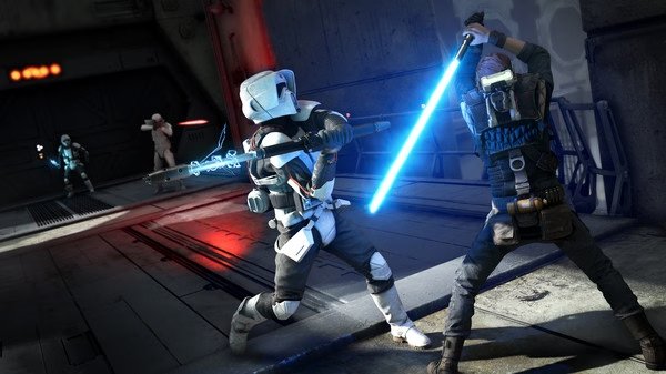 A screenshot from STAR WARS Jedi: Fallen Order showing a lightsaber duel between Cal Kestis and a stormtrooper in a dim hallway.