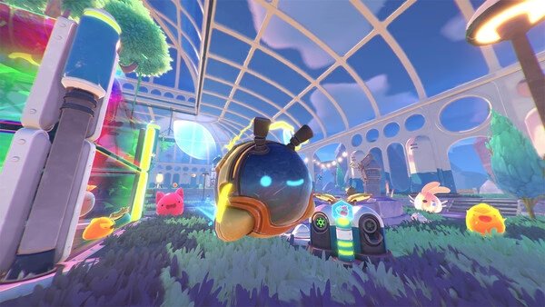 Slime Rancher 2 screenshot: A glowing slime wearing a helmet is surrounded by colorful slimes in a futuristic, glass-domed environment.