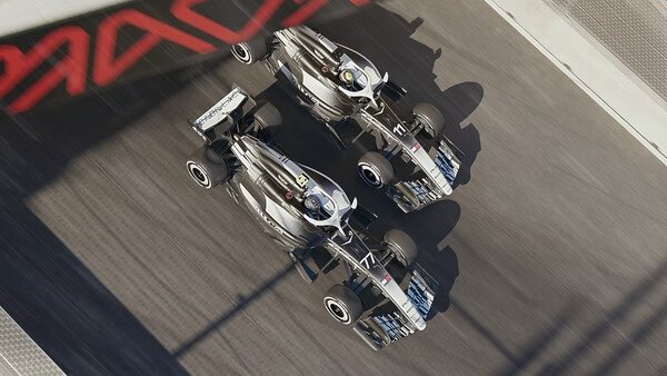 F1 25 screenshot: Two racing cars speed down a track side by side, showcasing intense competition and dynamic motion.
