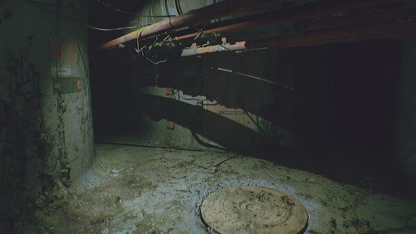 A screenshot from ROUTINE showing a dimly lit, decayed industrial corridor with pipes, wires, and a circular hatch on the floor.
