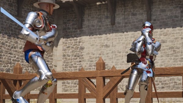 Two armored fighters duel with swords in a medieval arena in this Half Sword screenshot. Stone walls and wooden fencing surround them.