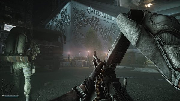 Escape from Tarkov screenshot: A player reloads their weapon while another character moves near a Terragroup building at night.