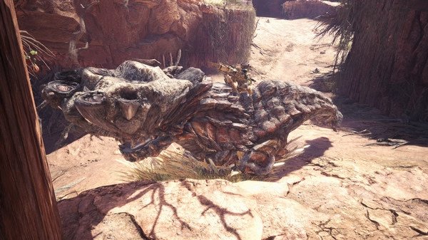 Monster Hunter: World screenshot featuring a hunter riding a massive, rocky monster in a sunlit canyon environment.