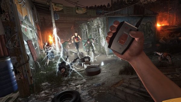 Dying Light screenshot: A hand holds a detonator in the foreground while zombies are electrified in a dark, rundown alley.