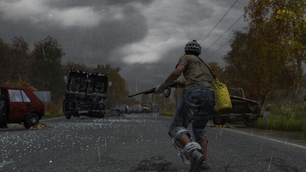 A DayZ screenshot showing a player with a rifle running down a rainy road, surrounded by abandoned vehicles and autumn trees.