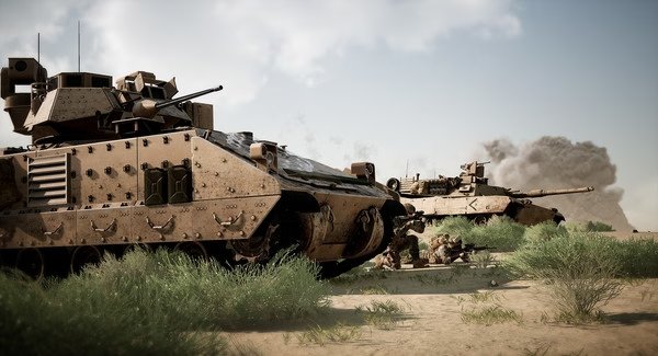 A Squad screenshot showing armored vehicles and soldiers in a desert environment with smoke rising in the background.