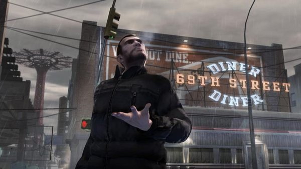 Grand Theft Auto IV screenshot: A character stands in front of a diner sign during a rainy day, gesturing with one hand.